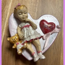 Beton hjerte med lille pige/bamse